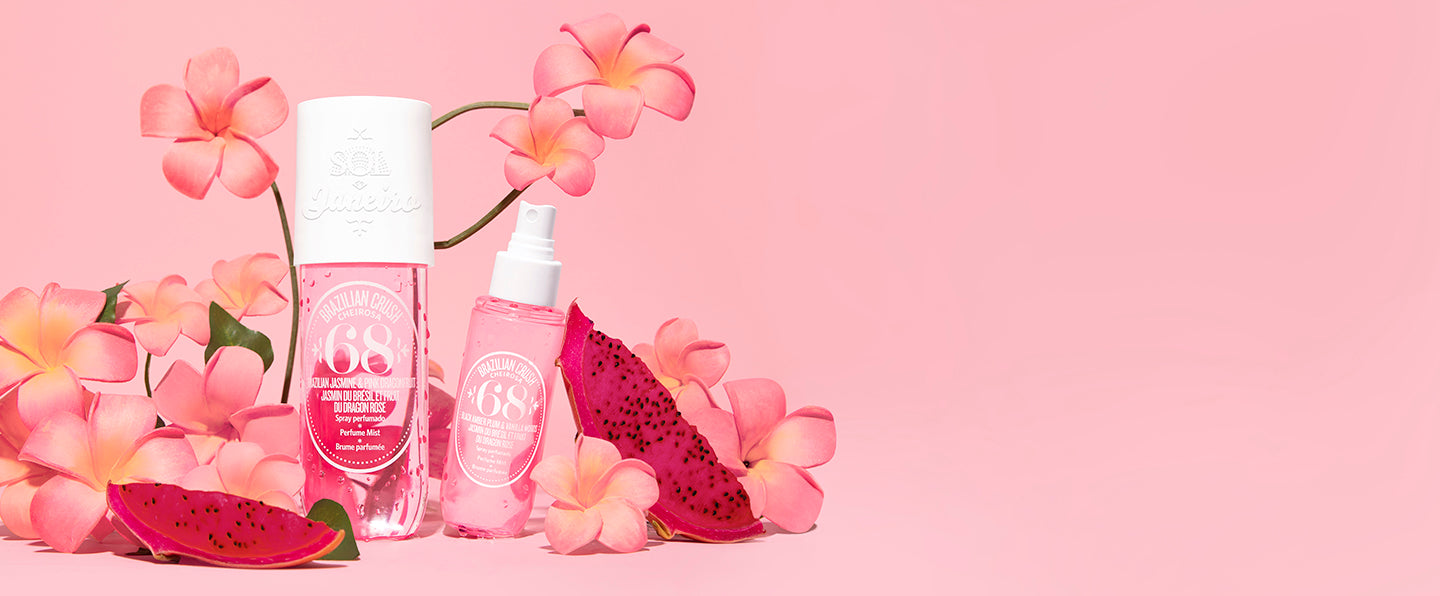 Cheirosa 68 perfume mists next to flowers on a pink background