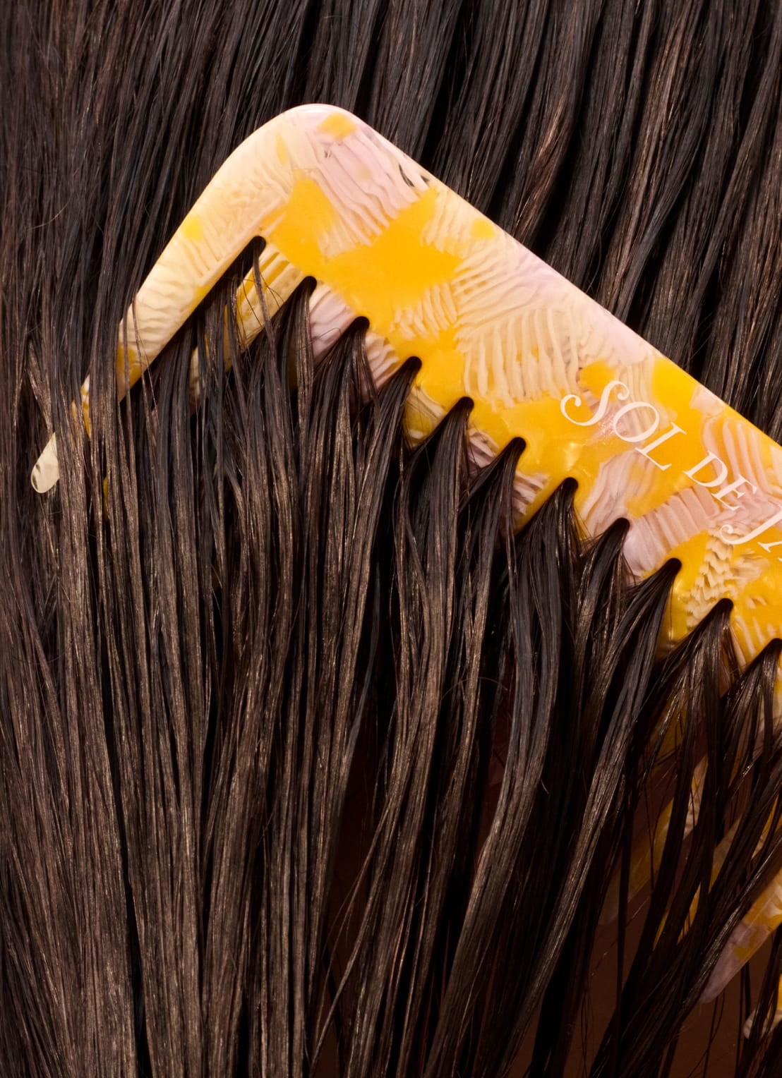 hair model with sol de janeiro comb