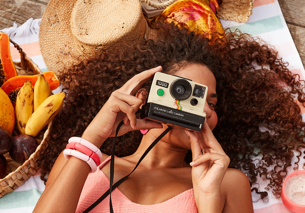 Curly haired woman holding a Camera