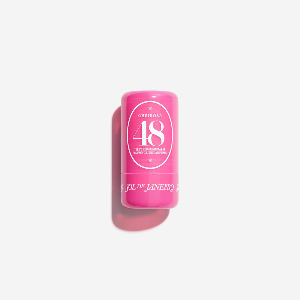 A pink cylindrical cosmetic stick container with a white circular label reading 'CHEEKIER 48' and 'STICK PERFUME BLOOM COLOR PERFUMING', photographed on a clean white background with a soft shadow.