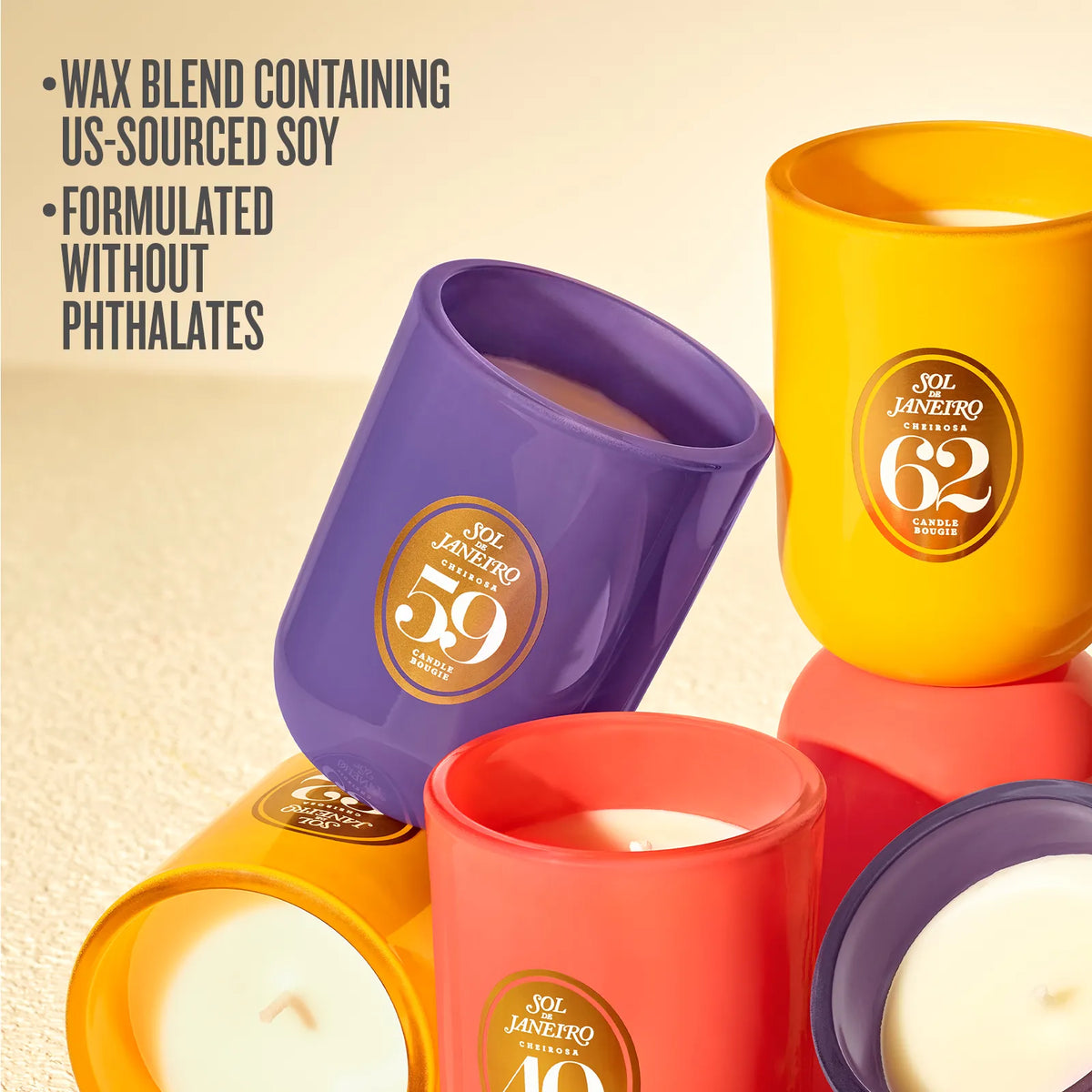 Several Sol Janvetro scented candles in colorful glass vessels are arranged on a light beige surface. Visible labels include 59, 40, 62, and 30.