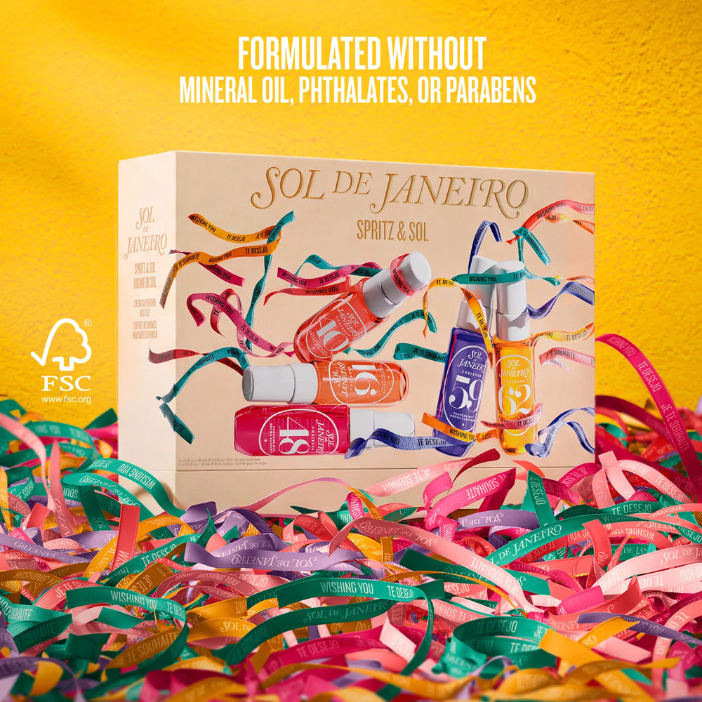 A boxed fragrance gift set labeled 'SOL DE JANEIRO SPRITZ & SOL' sits on colorful paper streamers against a bright yellow background. The box shows illustrated spray bottles in pink, orange, purple, and blue, with text stating the product is formulated without mineral oil, phthalates, or parabens.