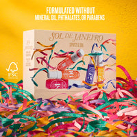 A boxed fragrance gift set labeled 'SOL DE JANEIRO SPRITZ & SOL' sits on colorful paper streamers against a bright yellow background. The box shows illustrated spray bottles in pink, orange, purple, and blue, with text stating the product is formulated without mineral oil, phthalates, or parabens.