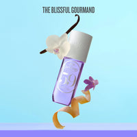 Perfume bottle with vanilla bean and orchid on a light blue background, featuring 'The Blissful Gourmand' brand.