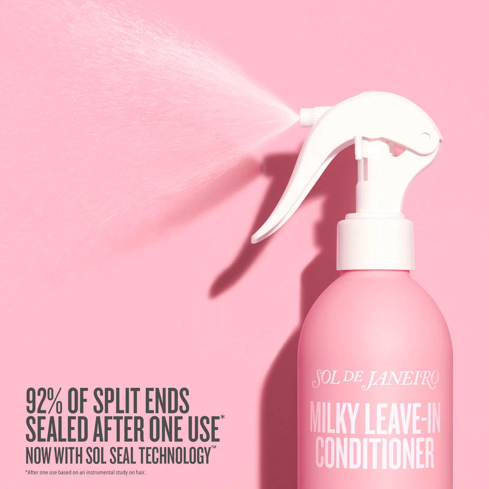 Pink Sol de Janeiro Milky Leave-In Conditioner bottle with white spray nozzle on a pink background