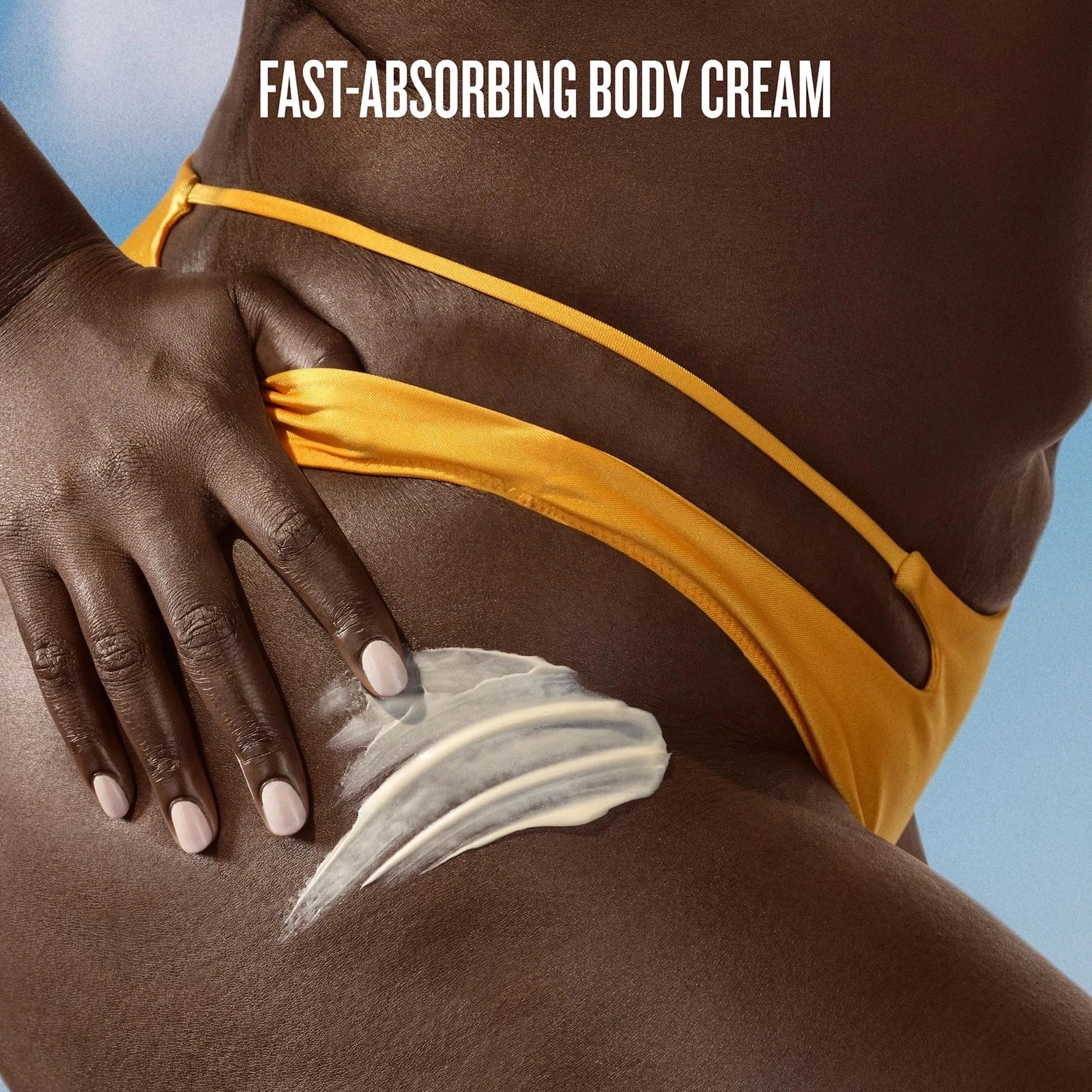 Person applying fast-absorbing body cream to their shoulder with a blue background