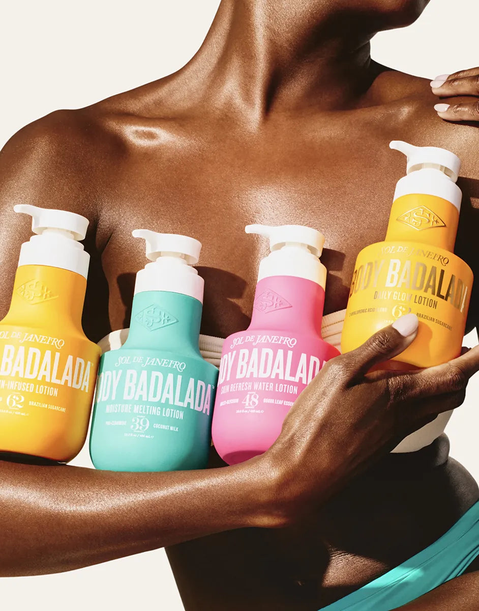 Person holding Badaladana lotion bottles with visible branding