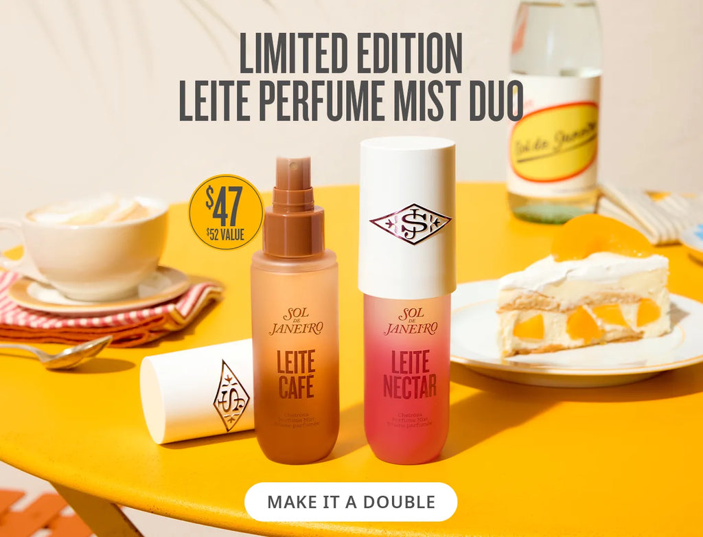 Two Leite perfume mist bottles on a yellow table with food items and a bottle of alcohol.