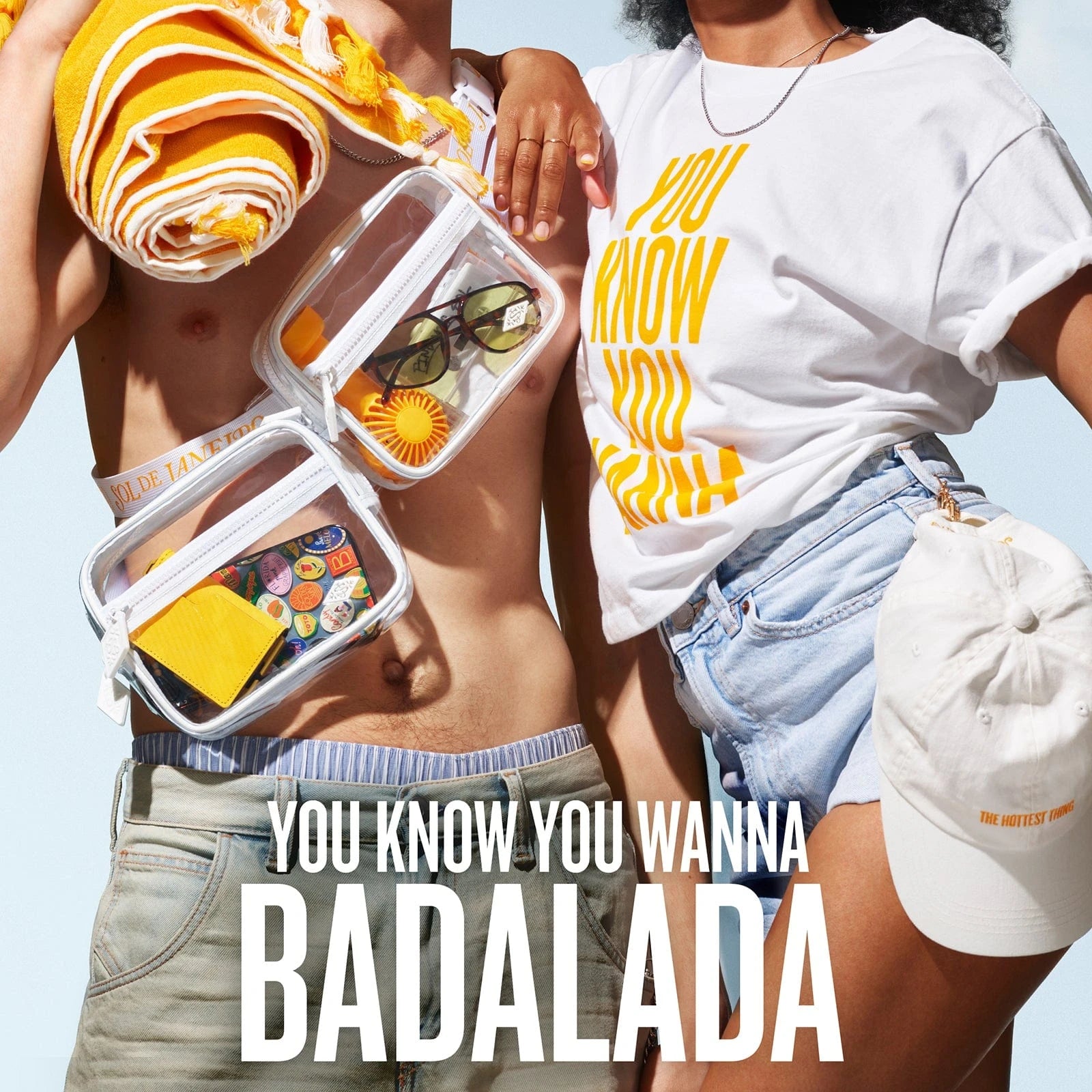 Text on image reads as follows, "you know you wanna badalda" Image showing models holding the baseball hat, stadium bag and beach towel