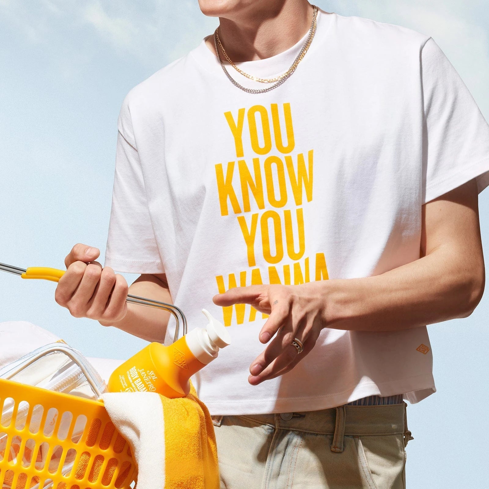 Another model wearing the sol de janeiro badalada t-shirt. T-shirt reads "you know you wanna'