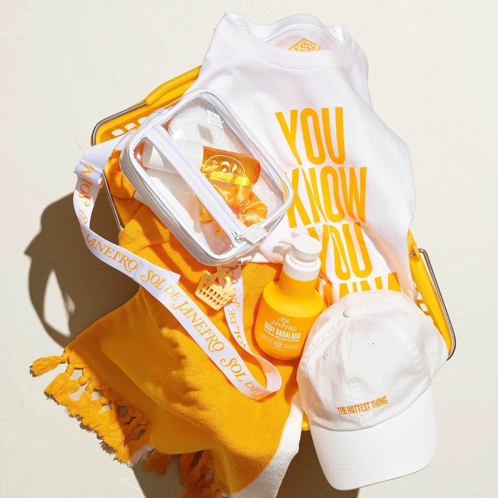 Sol de janeiro beach towel, t-shirt, crossbody bag and Badalada lotion all in asset