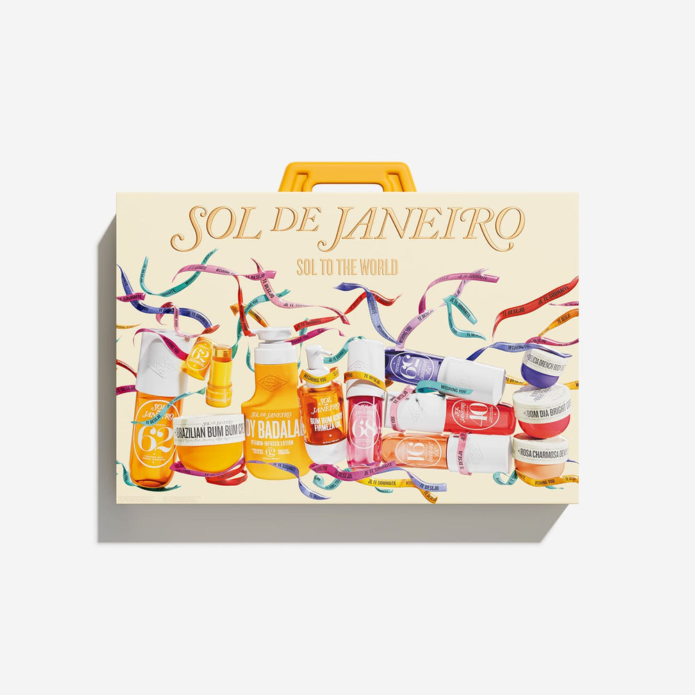 A rectangular carrying case with a yellow handle, printed with the text 'SOL DE JANEIRO' and 'SOL TO THE WORLD!' above a colorful illustration of assorted bottles and streamers, photographed on a light gray background.