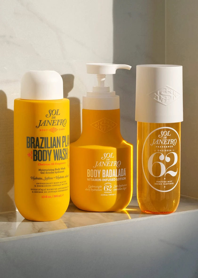 Three bottles of Sol de Janeiro body care products on a light surface with a neutral background.