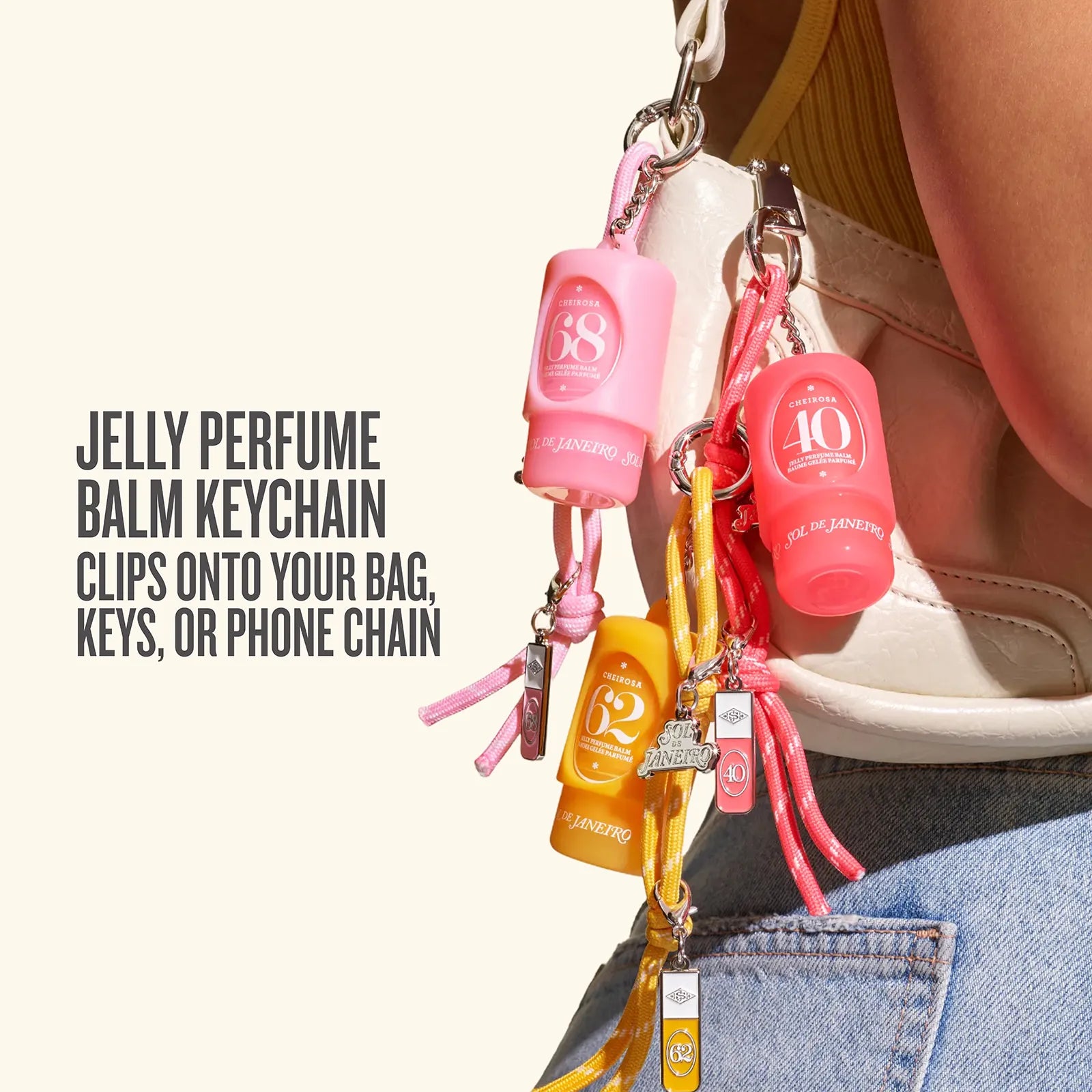 Pink and yellow personal care keychain set with SPF 38 and SPF 10 Balm units, clipped to a white shoulder bag with text on the left explaining its use.