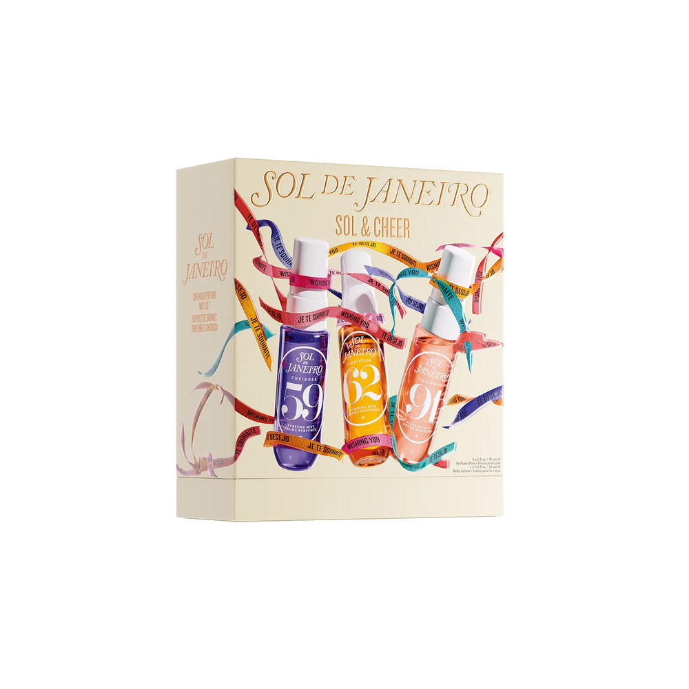 A boxed fragrance set labeled 'SOL DE JANEIRO' and 'SOL & CHEER' on a plain white background. The cream-colored box features illustrated colorful bottles and flowing ribbon graphics.