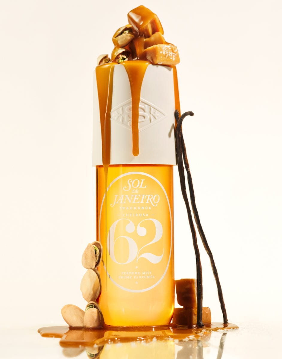 Bottle of 62  with caramel and vanilla beans on a white background
