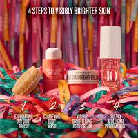 Four Sol Janfredo body care products arranged on colorful ribbon with a wooden brush, under the headline '4 STEPS TO VISIBLY BRIGHTER SKIN.' The products include an exfoliating dry body brush, clarifying body wash, visibly brightening body cream, and a sultry & delicate perfume mist.