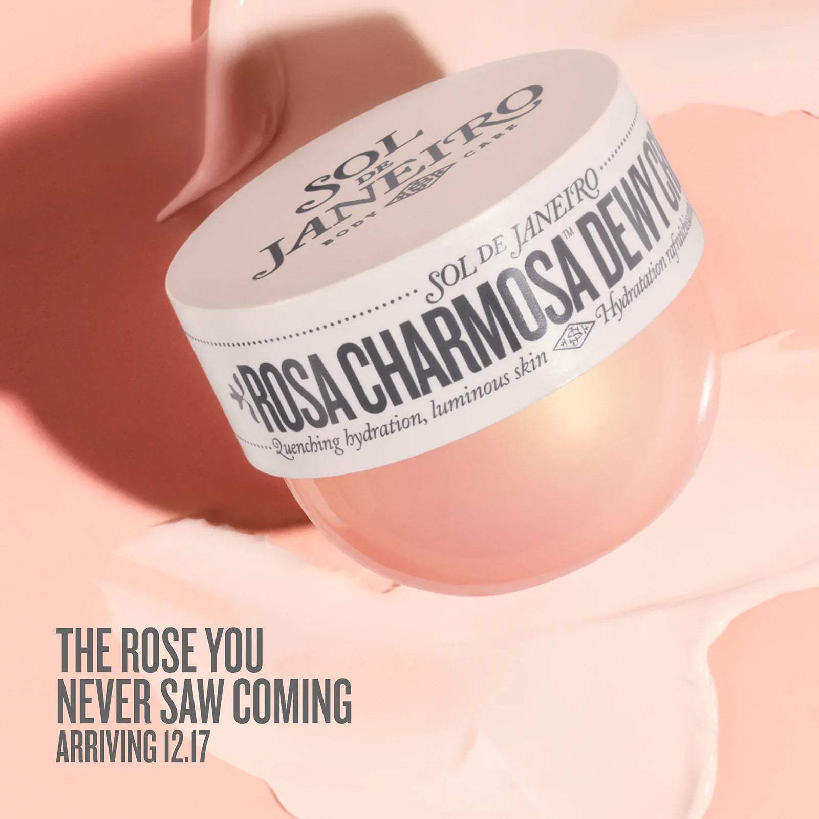 Cosmetic jar with 'Rosa Charmosa Dewy' text on a pink background. text on image reads the rose you never saw coming arriving 12.17