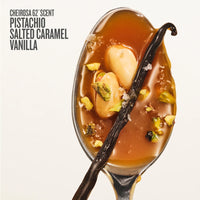 A spoonful of Cheirosa 62 Scent Pistachio Salted Caramel Vanilla fragrance, featuring rich amber-brown caramel sauce, whole pistachios, and a dark vanilla bean on a clean off-white background with text on the top left.