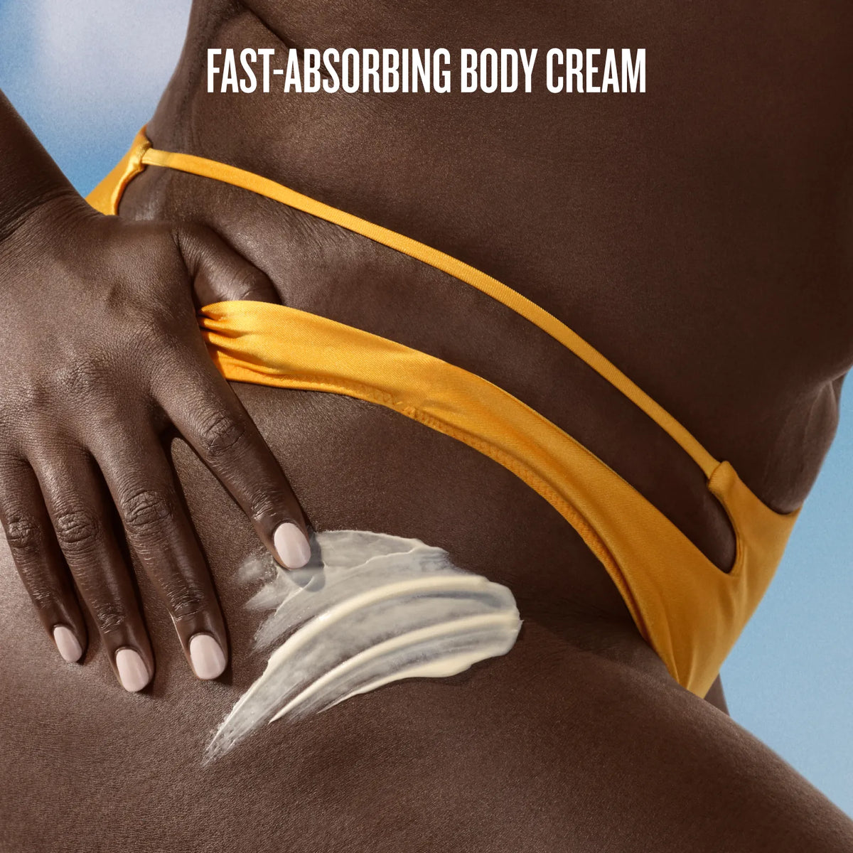 Close-up of a person applying white body cream to their hip, wearing a yellow bikini bottom against a blue sky background, with the text 'FAST-ABSORBING BODY CREAM' at the top.
