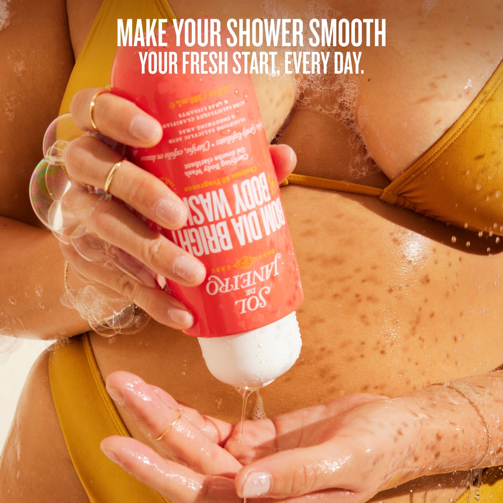 Person applying a bottle of body wash with text promoting a fresh start.