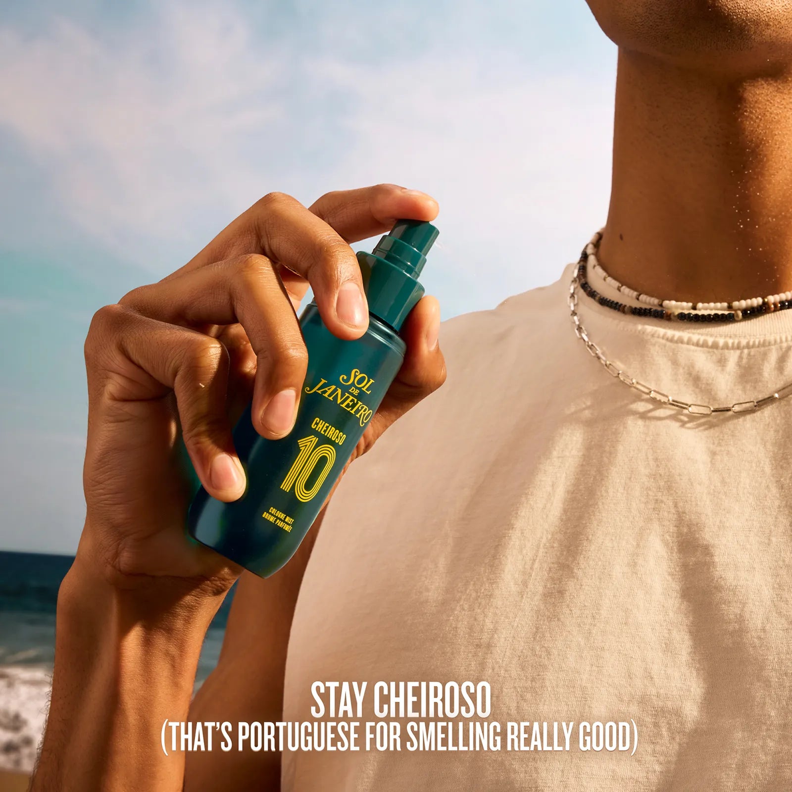 Person holding a spray bottle with a beach background and text &