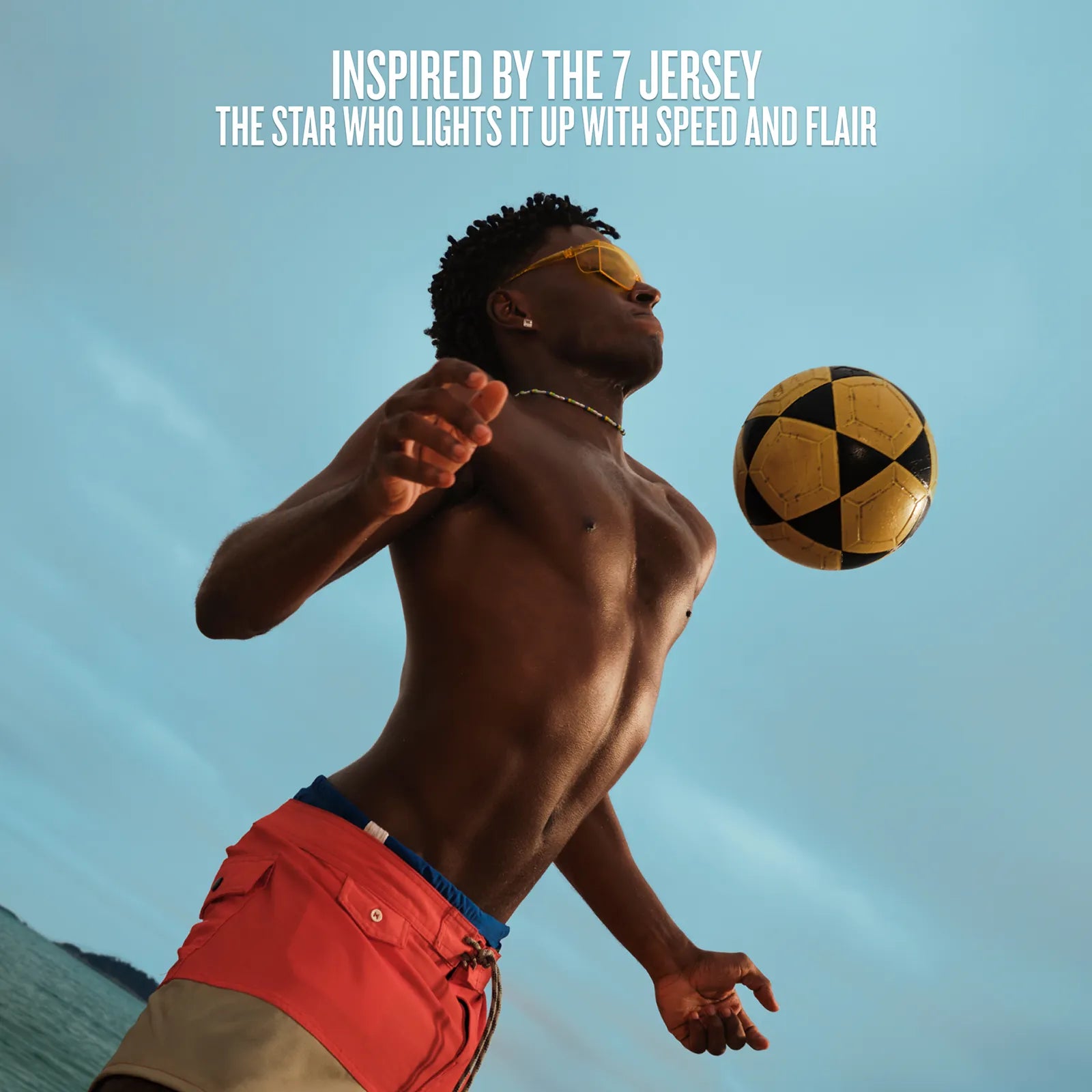Man playing with a soccer ball against a blue sky