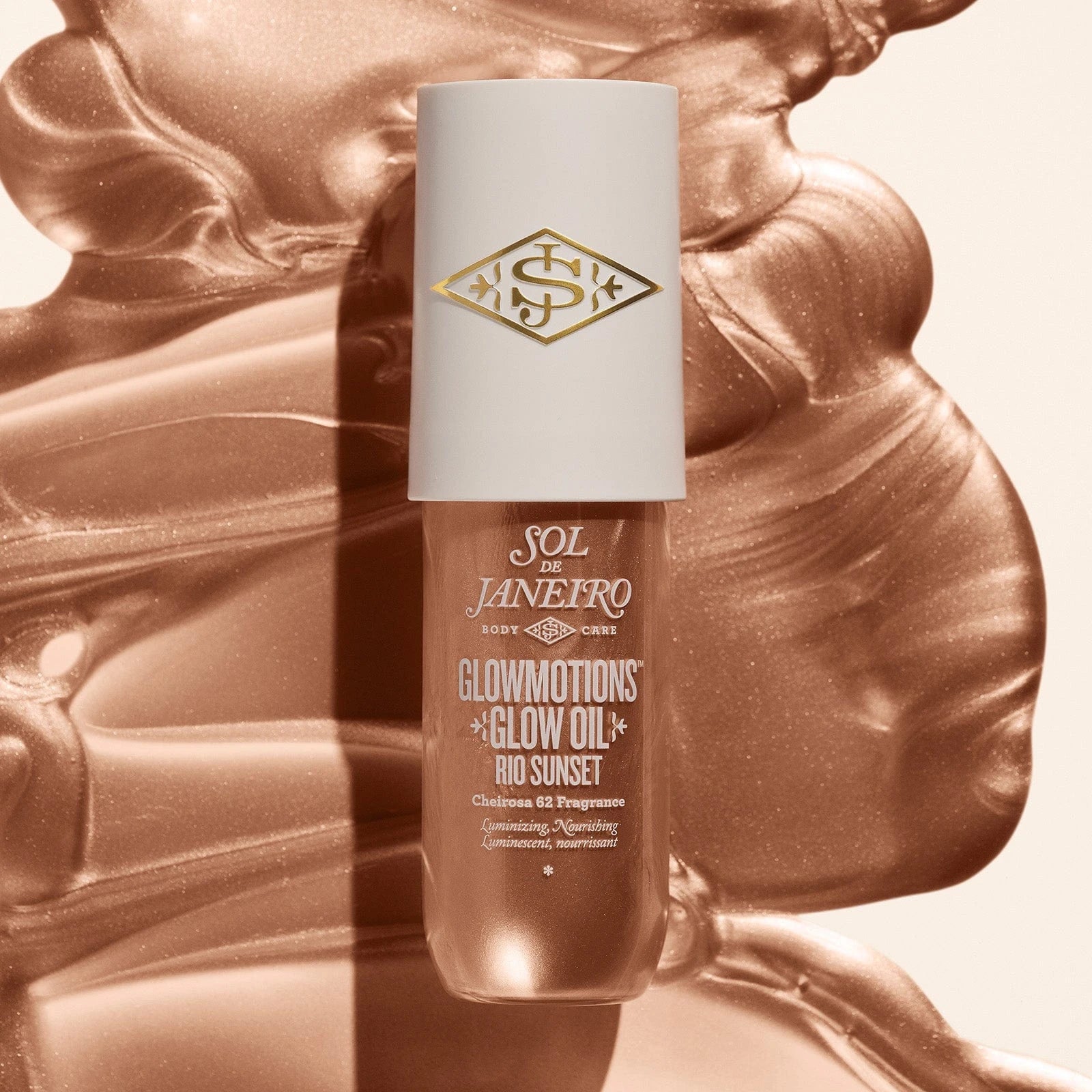 Image of the sol de janeiro glowmotions glow body oil in shade rio sunset spread out and you can really see how glowy bronze it is 