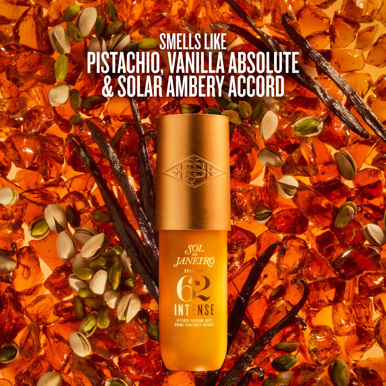 Sol Janeiro Intense 62 moisturizer bottle in a warm golden-amber color, centered against a textured background of amber glass pieces, vanilla beans, and pumpkin seeds. White text at the top reads: &