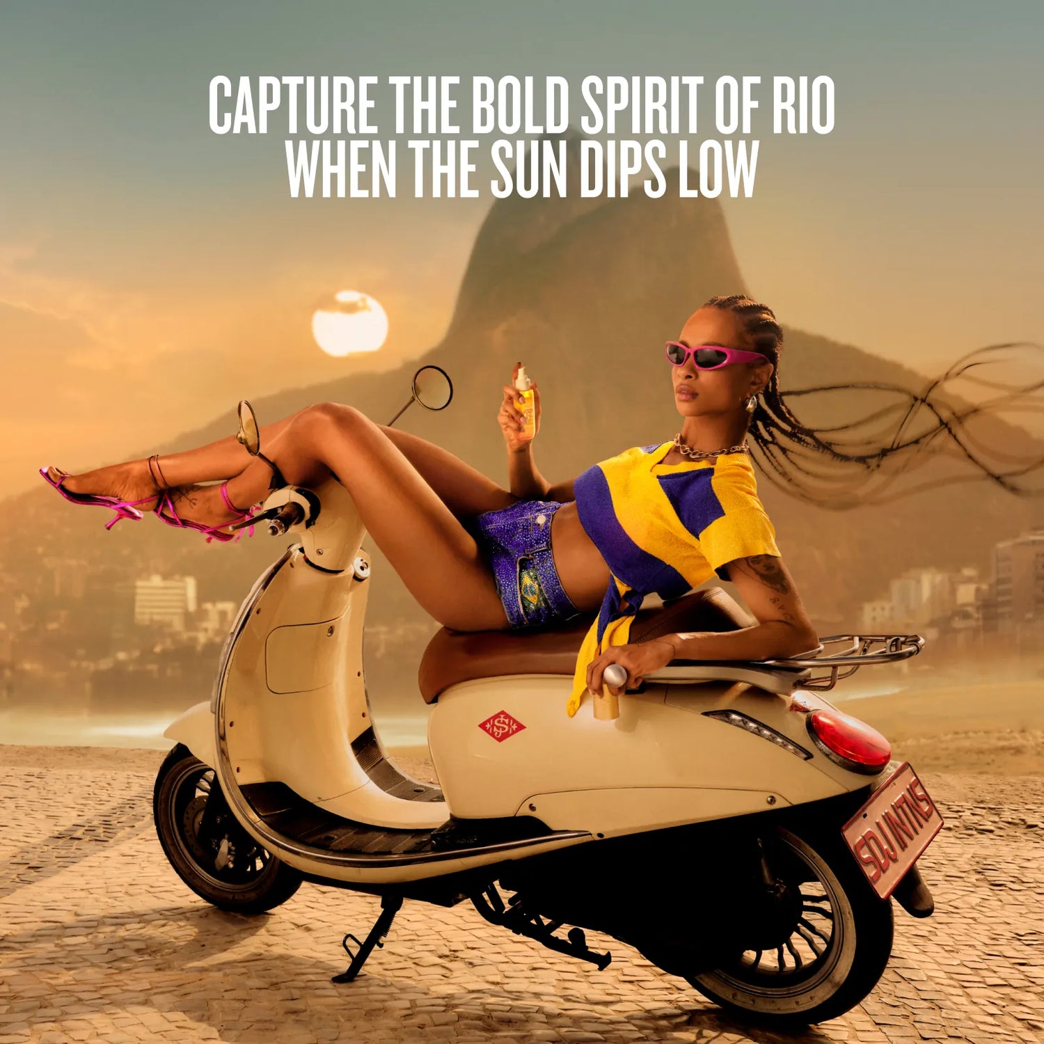 A woman reclining on a cream-colored scooter on a beach with a warm sunset sky, large text at the top reading &