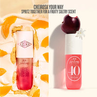 Two perfume bottles with fruit-themed packaging on a white background