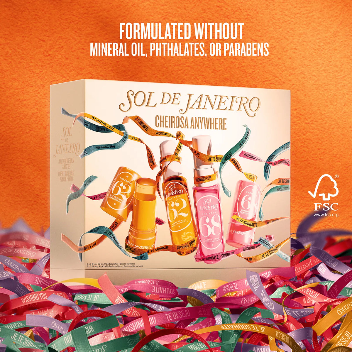 SOL DE JANEIRO Cheirosa Anywhere fragrance gift set box shown on an orange background with colorful confetti and ribbon-like strips around it. Text at the top reads 'FORMULATED WITHOUT MINERAL OIL, PHTHALATES, OR PARABENS' and an FSC logo appears on the right.