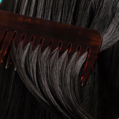 close up of black hair being combed